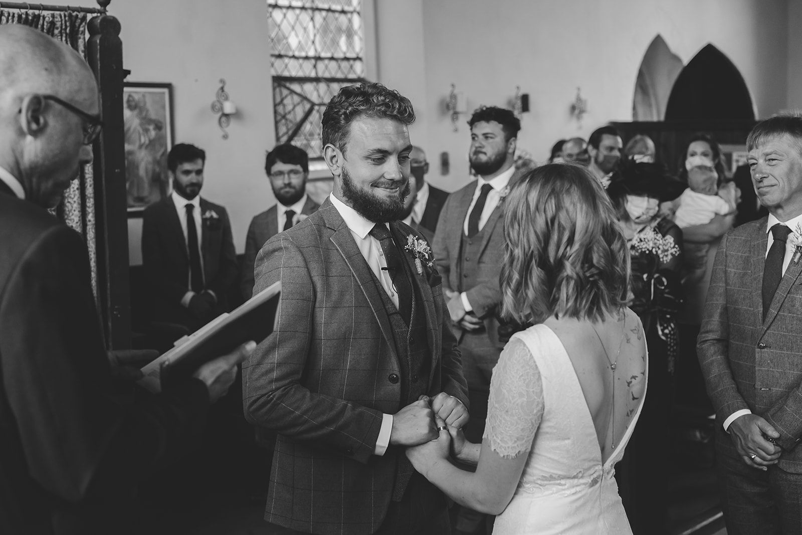 friends congratulating the groom at a Cripps Barn Winter Wedding